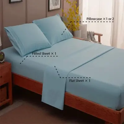 Luxurious brushed microfiber bed sheet set neatly arranged on a fluffy mattress in a calm morning bedroom