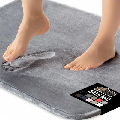 Plush cushioned memory foam mat placed alongside a bedroom platform bed on light oak hardwood floors