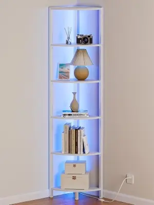 Modern 5-tier corner display shelf unit with soft built-in LED lighting illuminating books and plants in a cozy bedroom corner