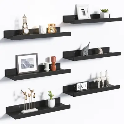 Minimalist rustic wooden floating shelves mounted on a serene bedroom accent wall holding potted succulents and framed prints