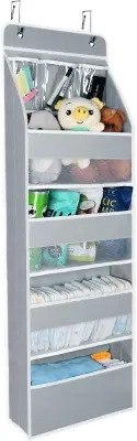 Durable multi-pocket over-the-door hanging organizer hanging behind a painted bedroom door neatly holding folded accessories