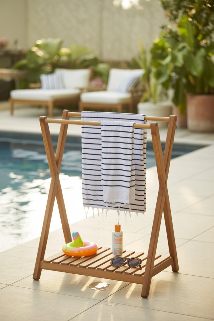8. A Towel Valet Stand with a Shelf for All-in-One Pool Organization
