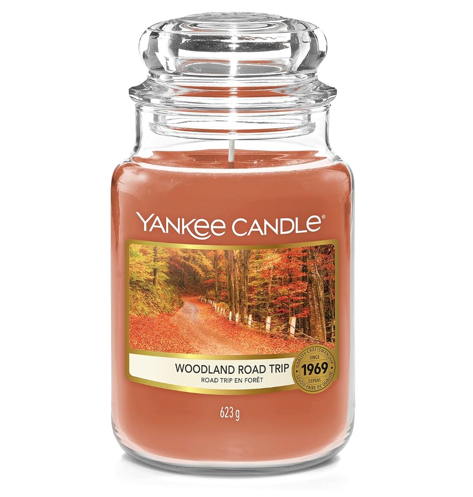 Smoky Fireside Candle in Concrete Jar Burning in Dimly Lit Living Room