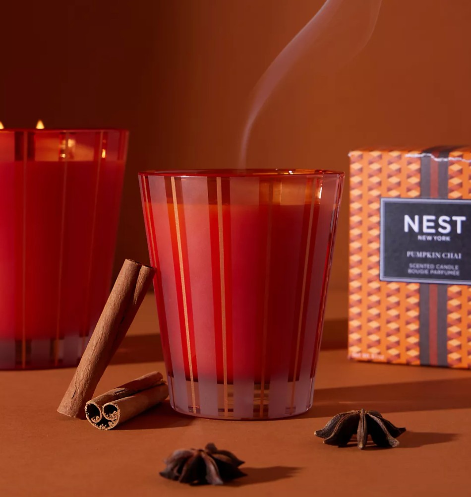 Amber Glass Spiced Pumpkin Candle Burning on Living Room Table