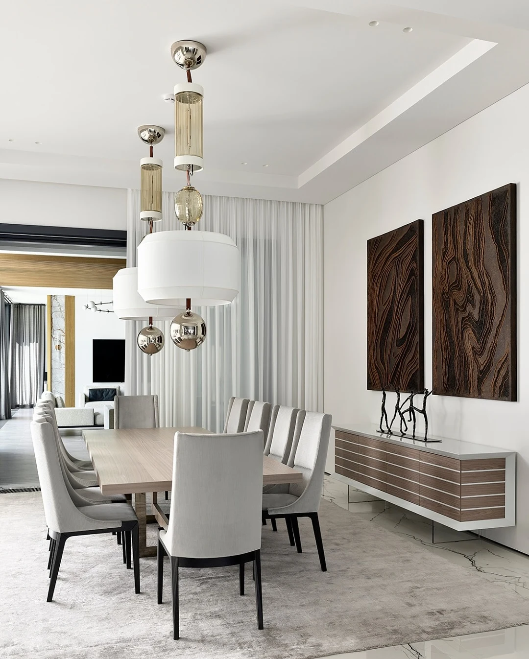 Layered Dining Room Lighting Combining a Center Chandelier with Wall Sconces