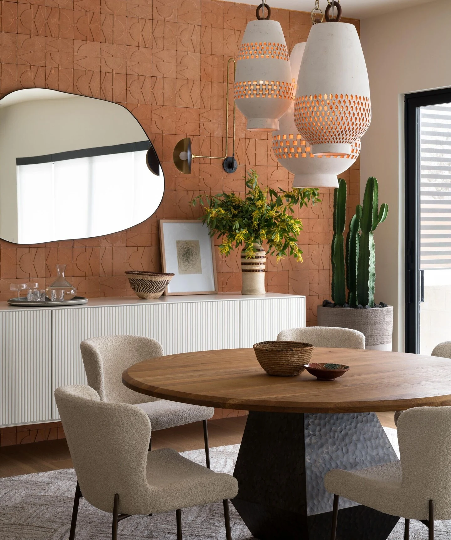 Woven Rattan Boho Pendant Light Over a Natural Wood Dining Table