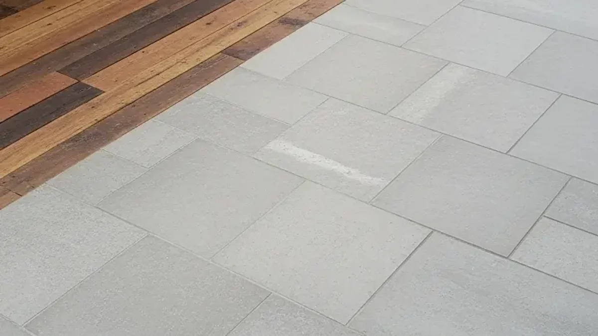 Natural stone pavers and reclaimed wood flooring pathway leading into an outdoor kitchen