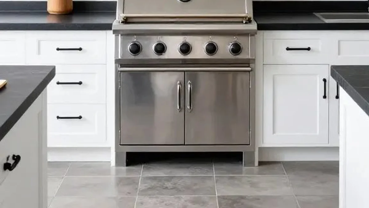 Matte black iron drawer pulls and honed dark soapstone counters against white farmhouse outdoor cabinetry