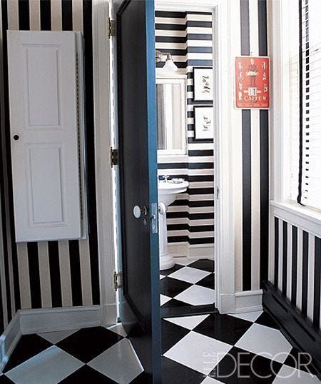 Black Flooring Paired with Light Walls in Bedroom