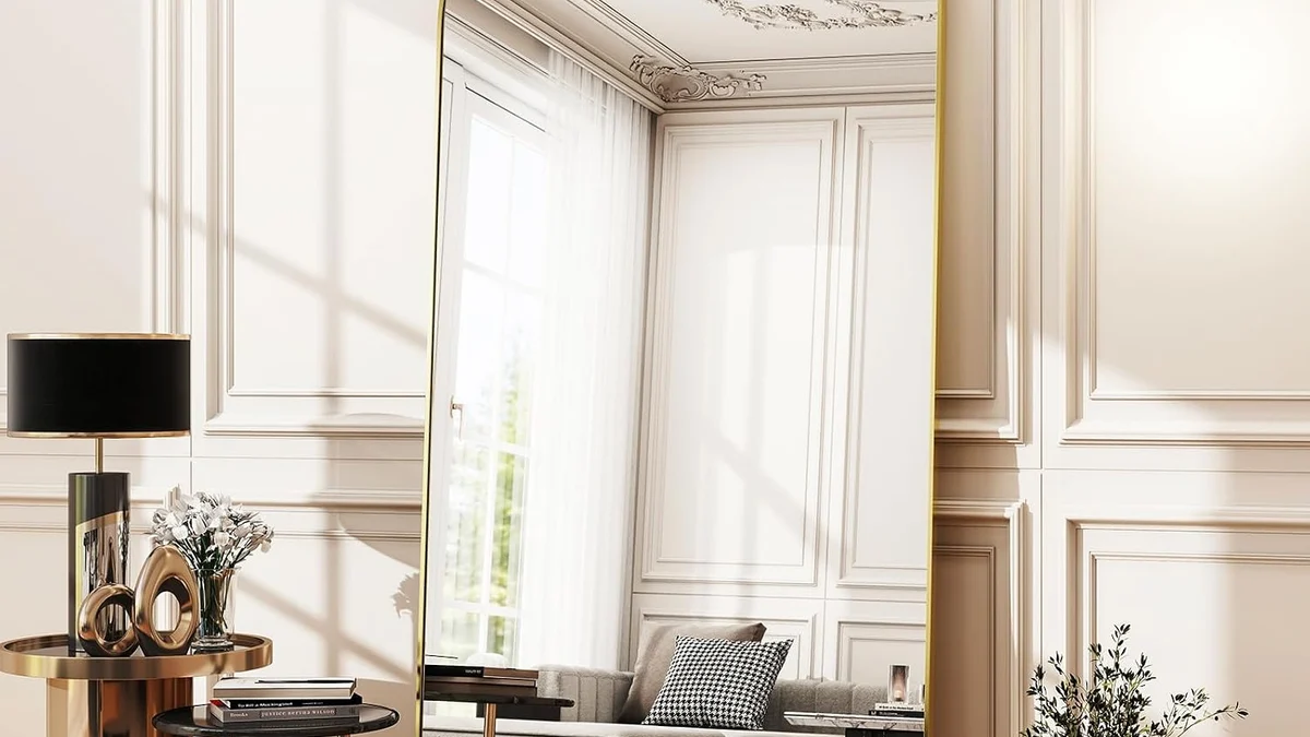 Designer Arched Brass Full-Length Mirror leaning against paneled bedroom wall