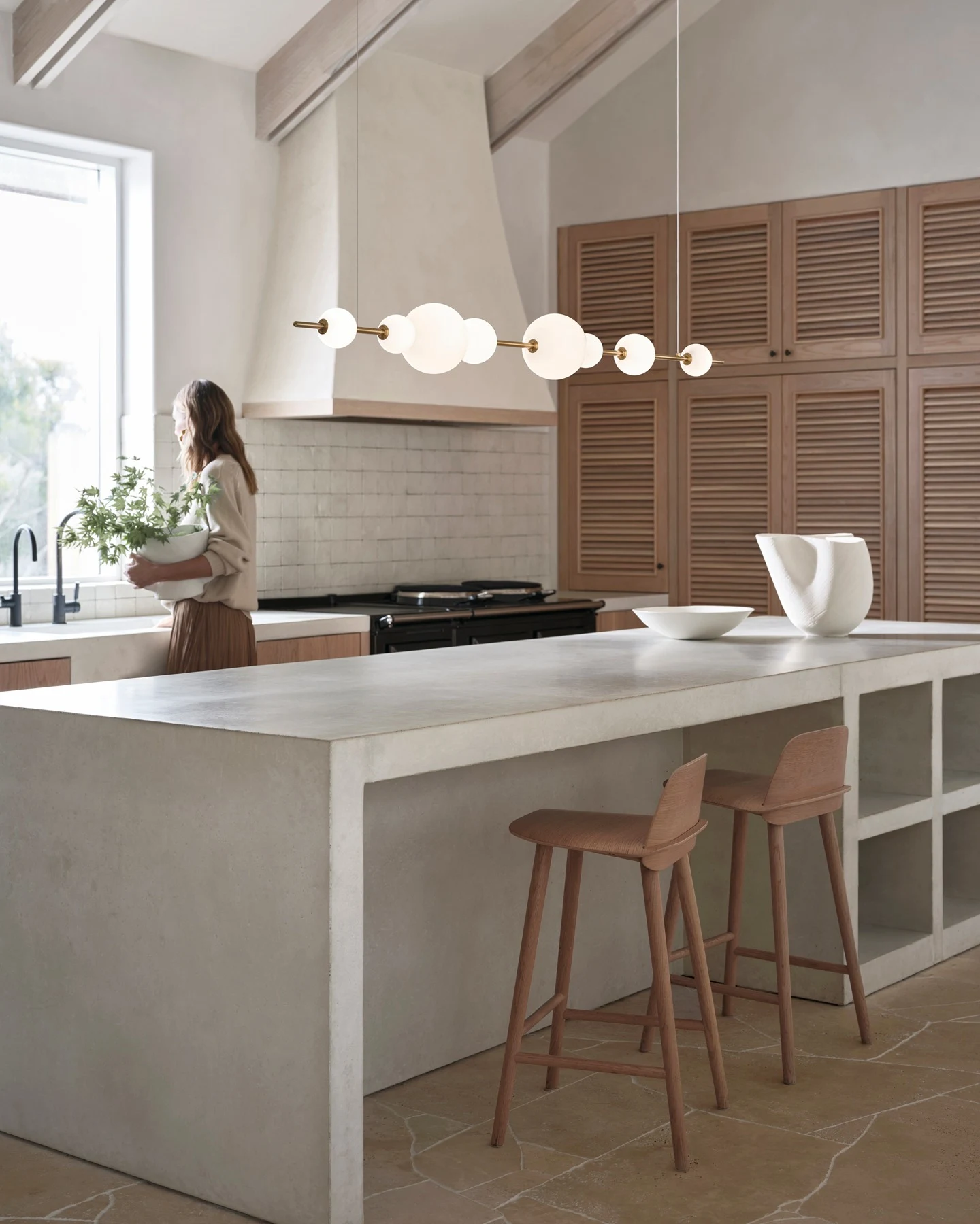Sculptural Asymmetrical Pendant Lighting Over a Modern Kitchen Island
