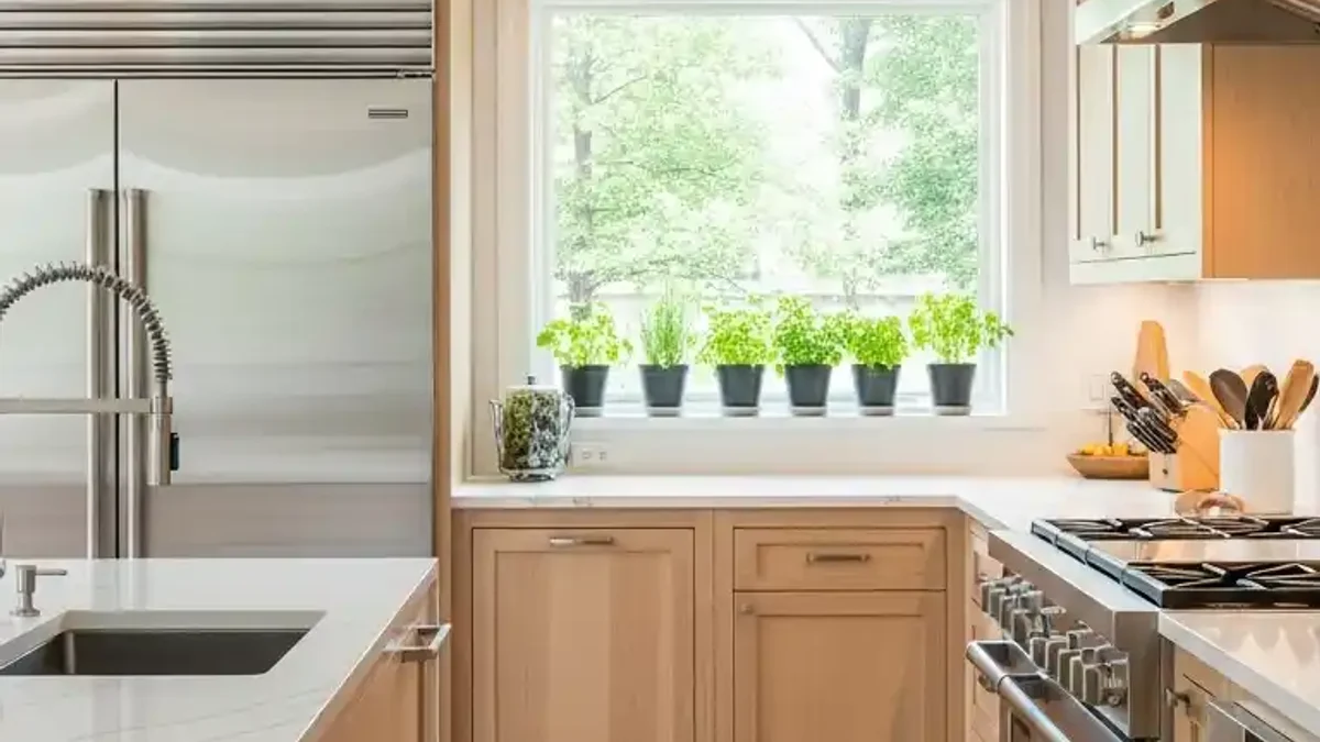 Smooth Natural Maple kitchen cabinetry in a bright versatile kitchen