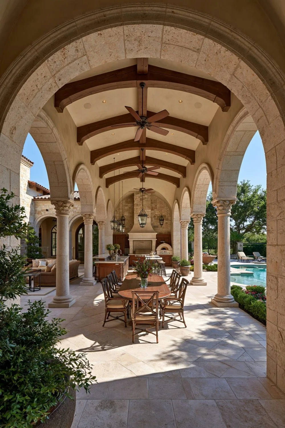 10. An Outdoor Kitchen and Dining Area Under a Pergola for Al Fresco Living
