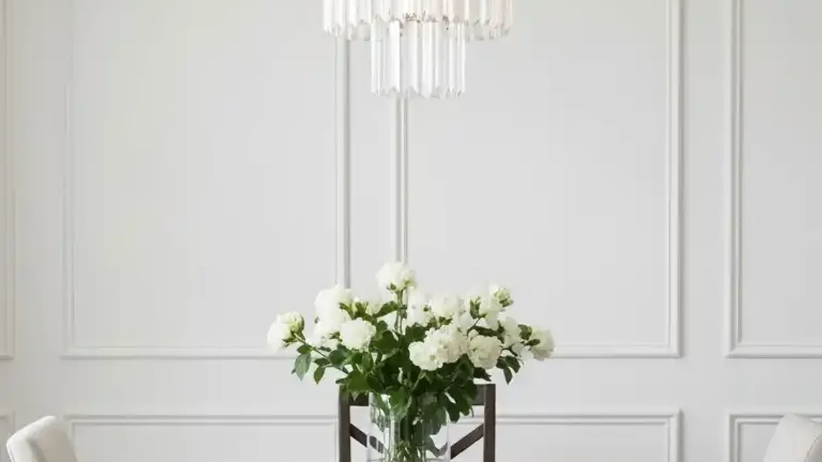 Warm statement pendant light suspended over a compact dining table