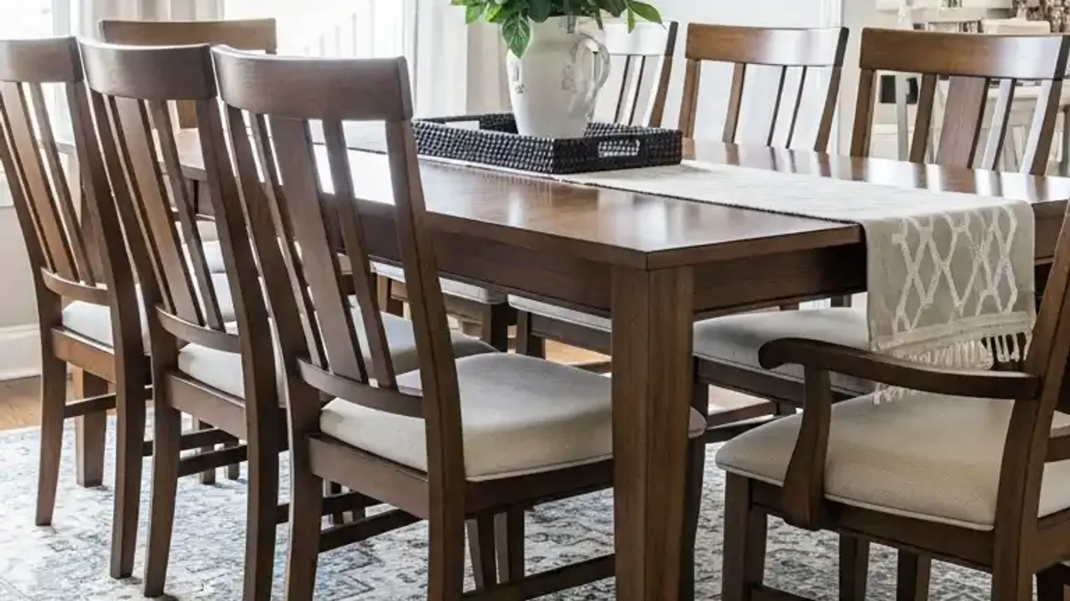 Compact dining room anchored by a warm patterned area rug beneath the table
