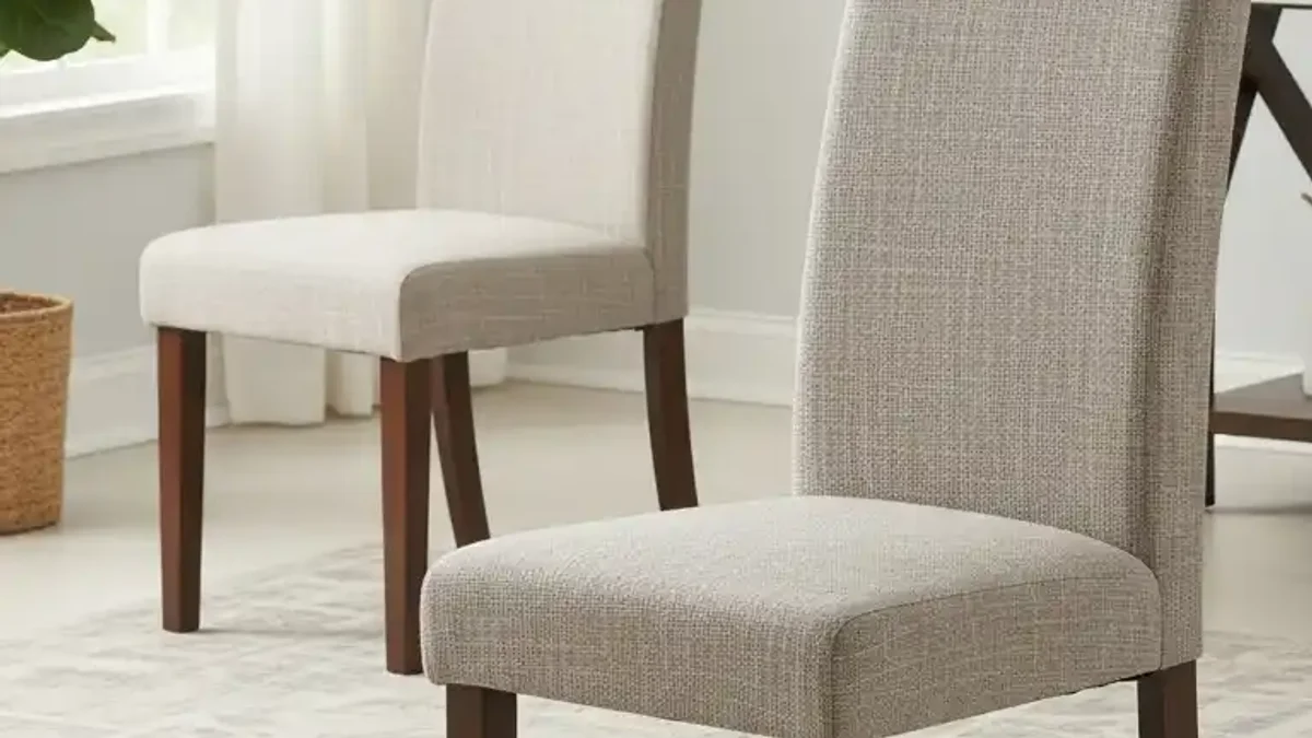 Slim armless dining chairs tucked neatly around a small dining table