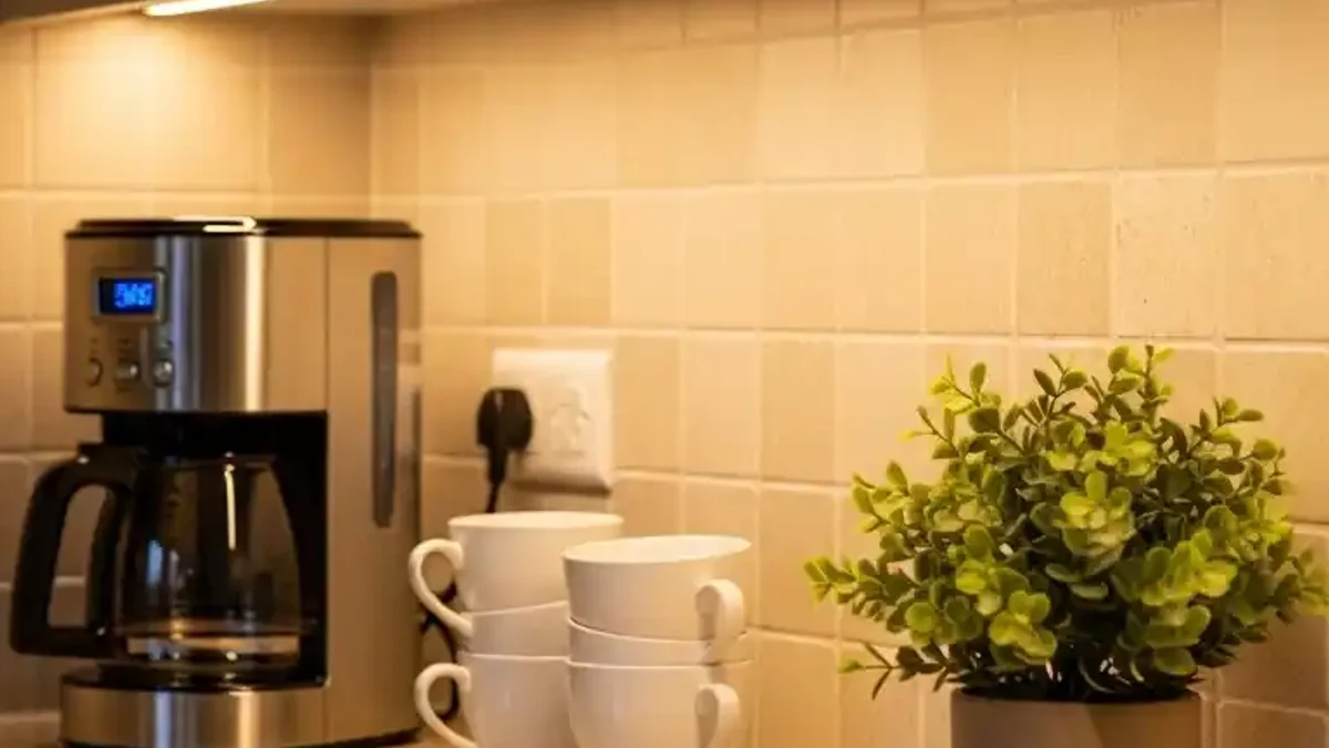 Dimmable under-cabinet LED lights toned down to a soft ambient glow in an evening kitchen setting